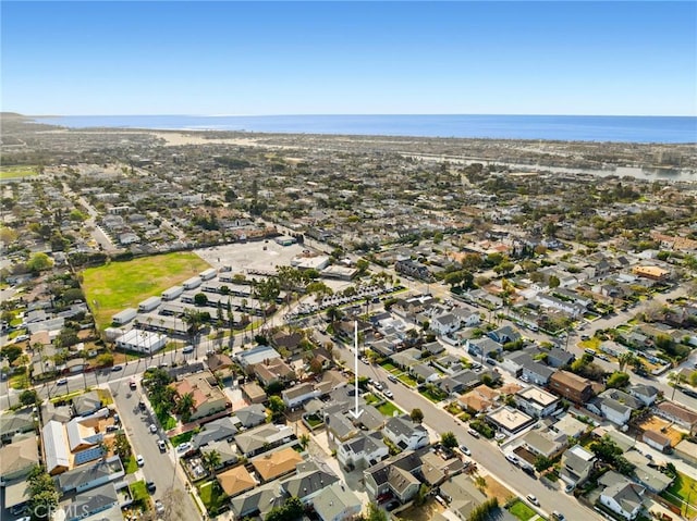 drone / aerial view with a water view and a residential view