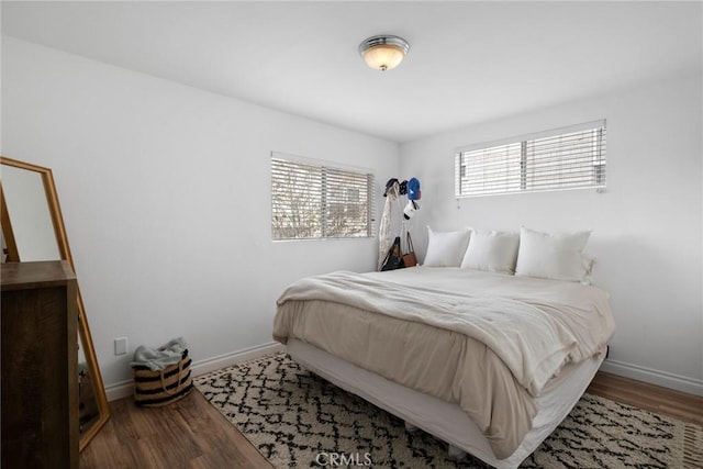 bedroom with baseboards and wood finished floors