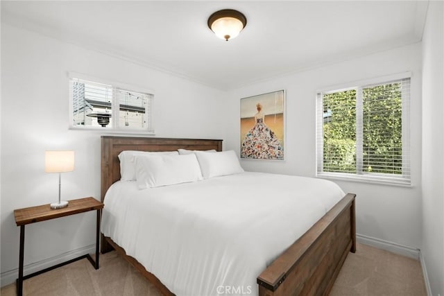 carpeted bedroom featuring baseboards and ornamental molding