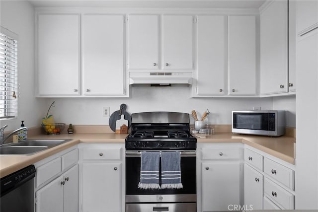 kitchen featuring under cabinet range hood, appliances with stainless steel finishes, white cabinetry, and a sink