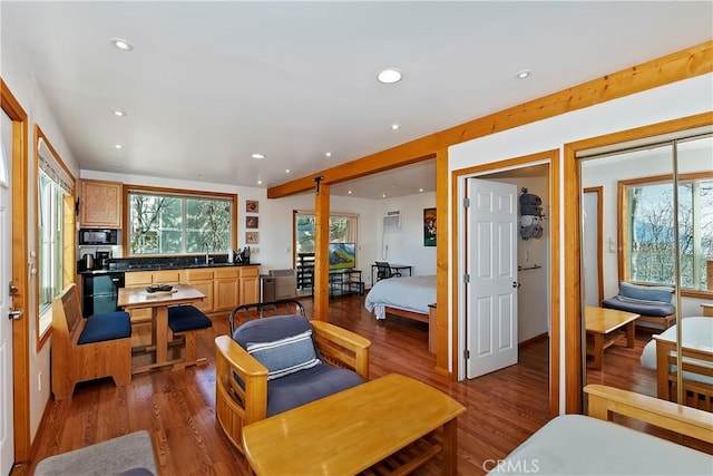 living room with hardwood / wood-style flooring and sink