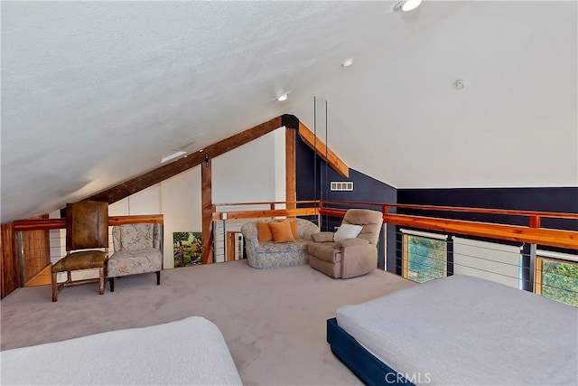 bedroom featuring vaulted ceiling, carpet, and a textured ceiling