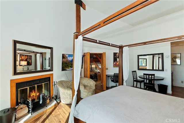 bedroom with wood-type flooring and vaulted ceiling