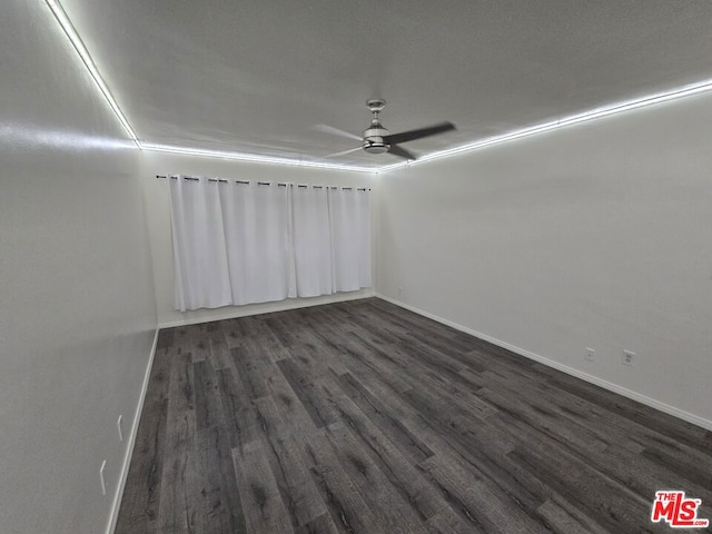 spare room with ceiling fan and dark hardwood / wood-style flooring