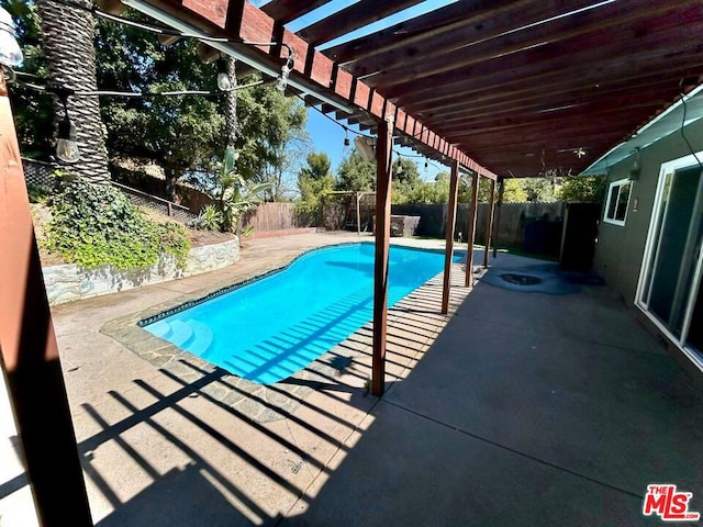 view of swimming pool featuring a patio and a pergola