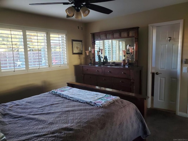 bedroom featuring ceiling fan, carpet flooring, and multiple windows