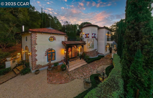 mediterranean / spanish-style home with a patio and a balcony