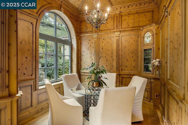 dining area featuring a notable chandelier, crown molding, and wood-type flooring