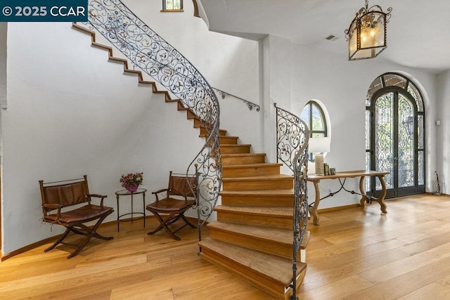 foyer entrance with light hardwood / wood-style floors and french doors