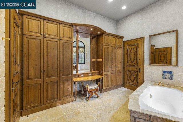 bathroom with tiled tub