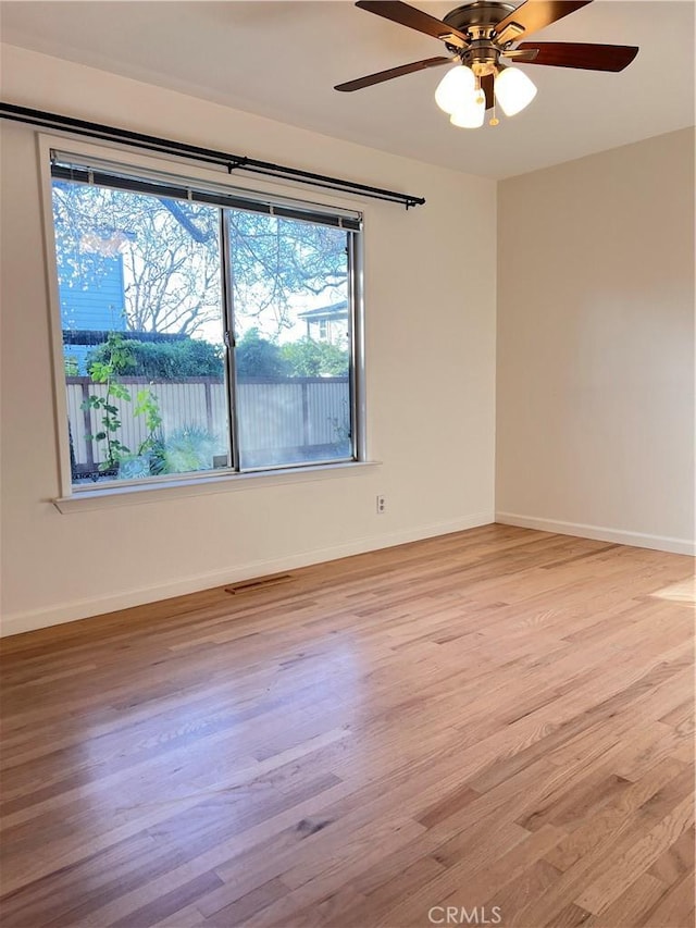 empty room featuring ceiling fan and light hardwood / wood-style flooring