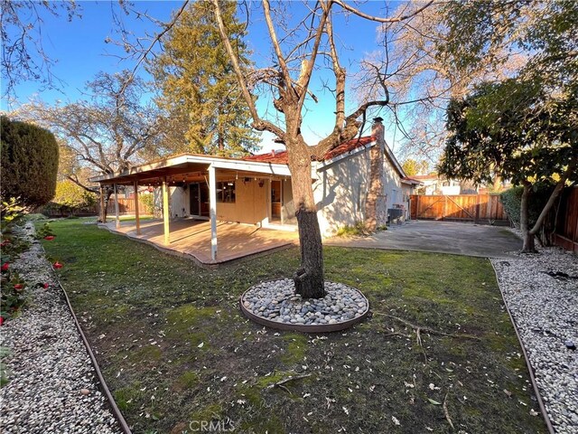 back of property featuring a patio and a lawn