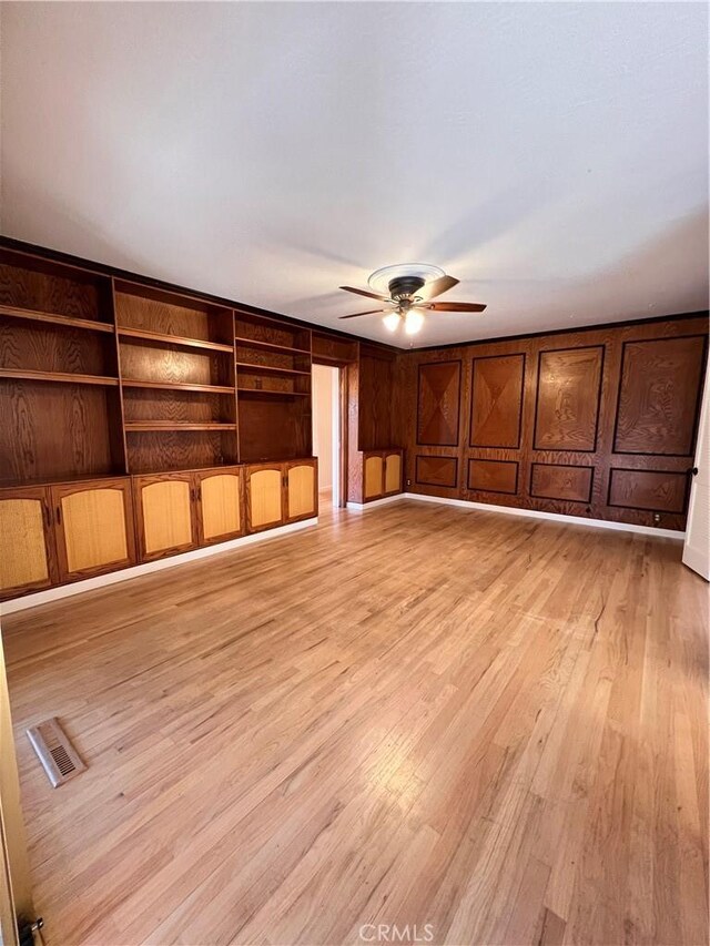 unfurnished living room with ceiling fan and light wood-type flooring