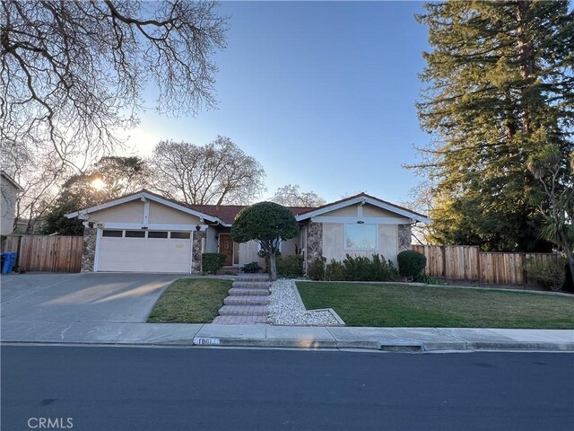 view of front of home featuring a garage and a lawn