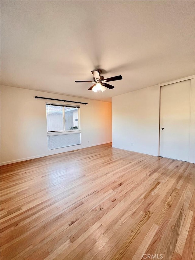 unfurnished room with light hardwood / wood-style flooring and ceiling fan