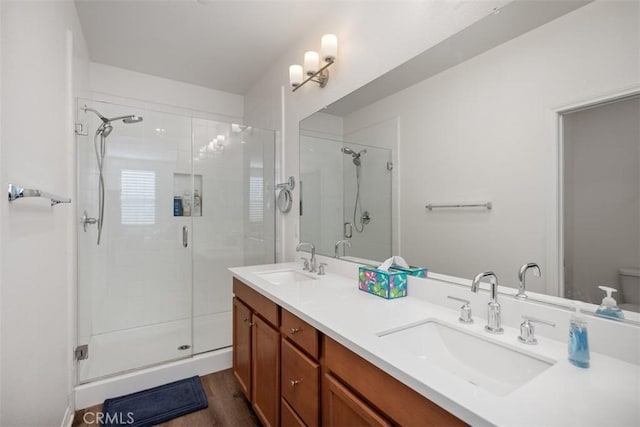 bathroom with vanity, an enclosed shower, hardwood / wood-style floors, and toilet