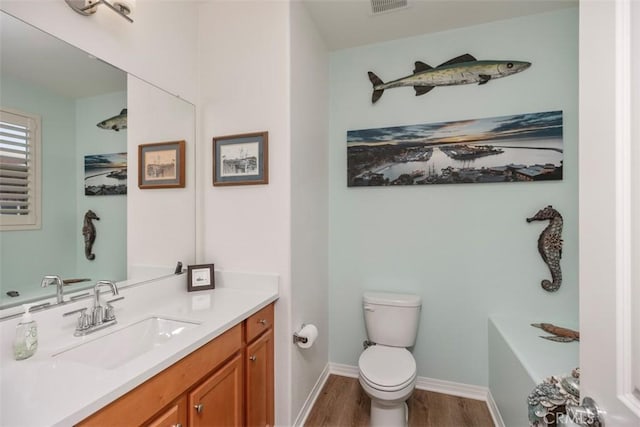 bathroom featuring hardwood / wood-style flooring, vanity, and toilet