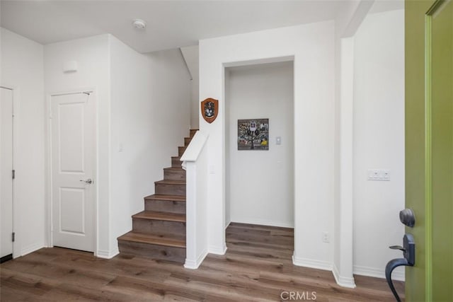 stairs with hardwood / wood-style flooring