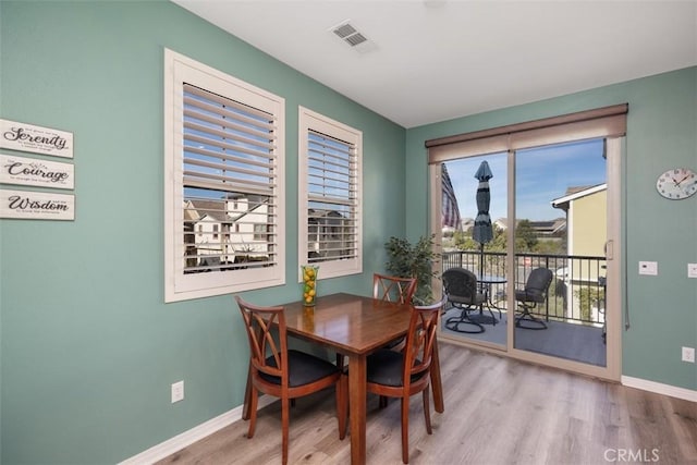 dining area with light hardwood / wood-style floors