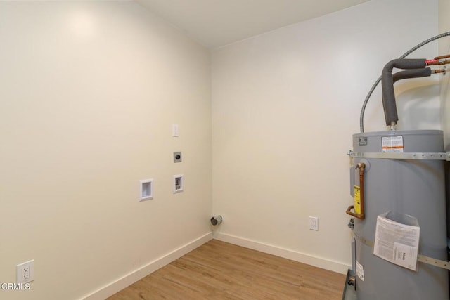 laundry area with laundry area, baseboards, light wood-style flooring, hookup for a washing machine, and electric dryer hookup