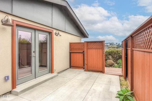 exterior space featuring french doors and a gate