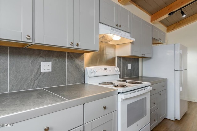 kitchen with stainless steel counters, under cabinet range hood, electric range, and decorative backsplash