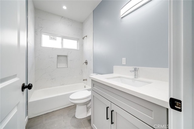 full bathroom featuring tiled shower / bath, vanity, toilet, and tile patterned floors