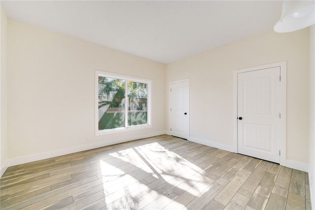 unfurnished room with light wood-type flooring