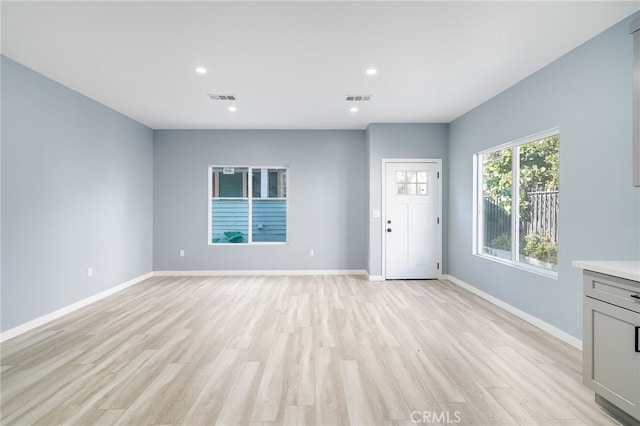 unfurnished living room with light hardwood / wood-style floors