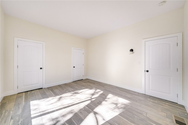 empty room with light wood-type flooring