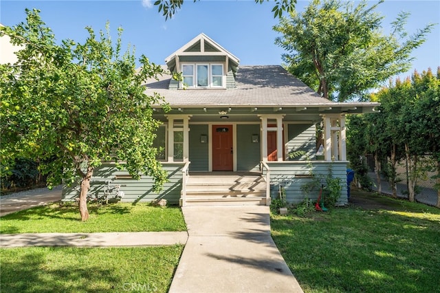 view of front of home featuring a porch and a front lawn