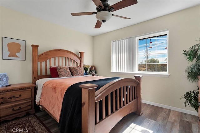 bedroom with ceiling fan and dark hardwood / wood-style floors