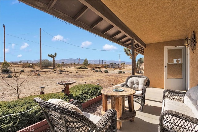 view of patio featuring a rural view and a mountain view