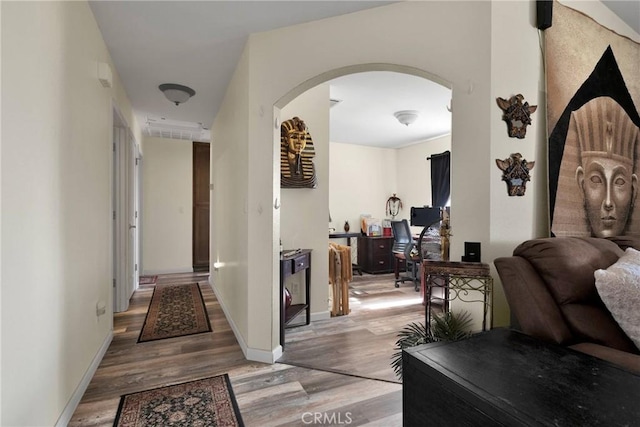 hallway with hardwood / wood-style flooring