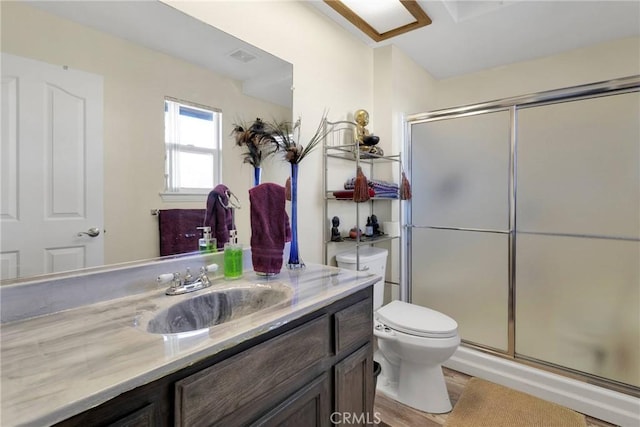 bathroom featuring hardwood / wood-style flooring, vanity, an enclosed shower, and toilet