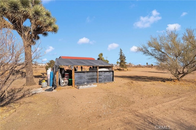 view of yard with an outdoor structure and a rural view