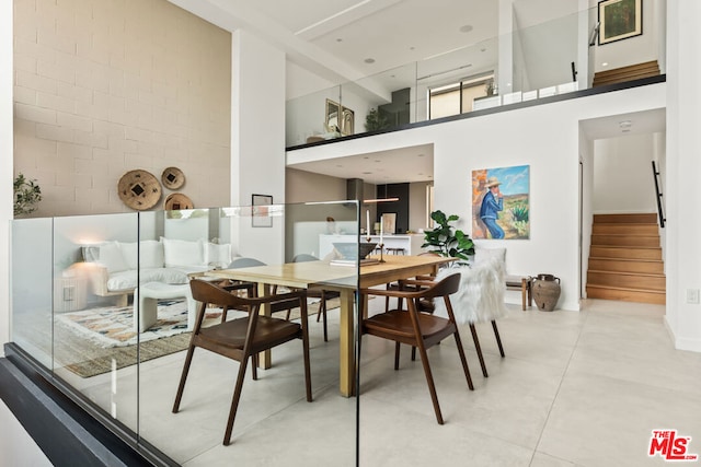 dining space featuring a high ceiling