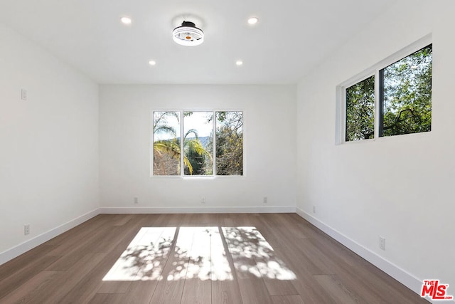 spare room featuring dark hardwood / wood-style floors