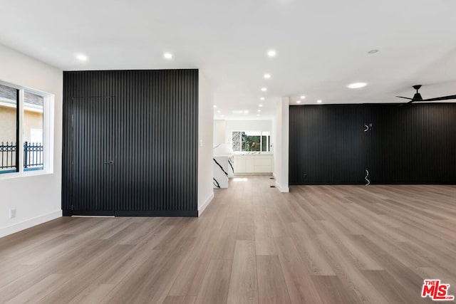 spare room featuring ceiling fan and light hardwood / wood-style flooring