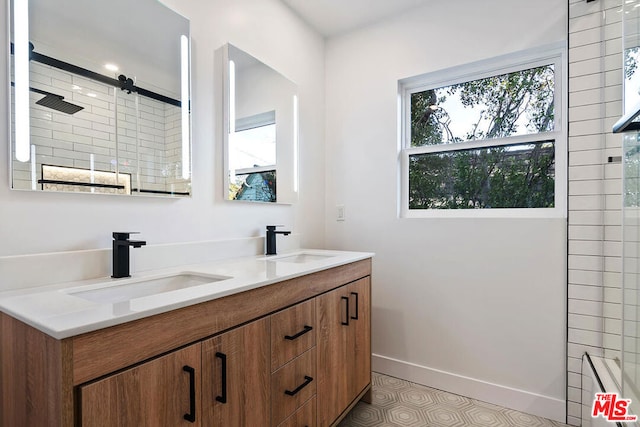 bathroom featuring vanity, a shower with shower door, and tile patterned floors