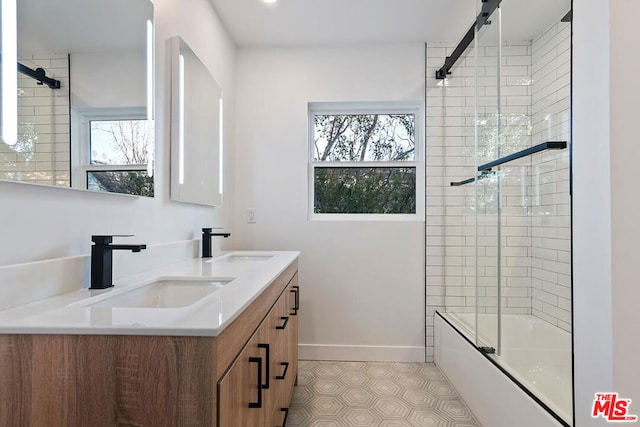 bathroom with tile patterned flooring, vanity, combined bath / shower with glass door, and plenty of natural light