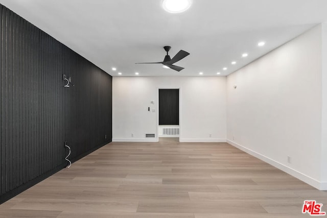 empty room featuring ceiling fan and light wood-type flooring