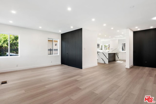 unfurnished living room featuring light wood-type flooring