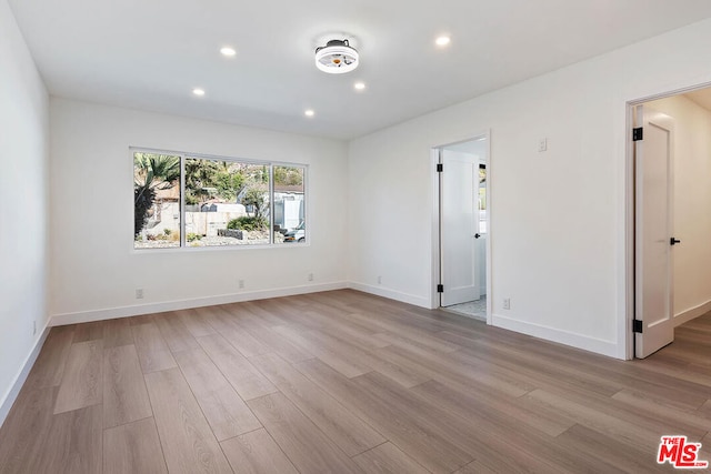 unfurnished room with light wood-type flooring