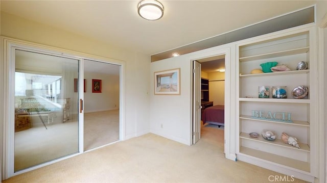 unfurnished bedroom with light carpet and a closet