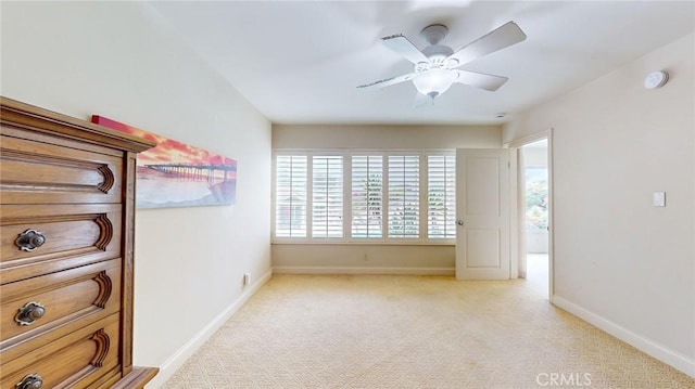 unfurnished bedroom featuring light colored carpet and ceiling fan