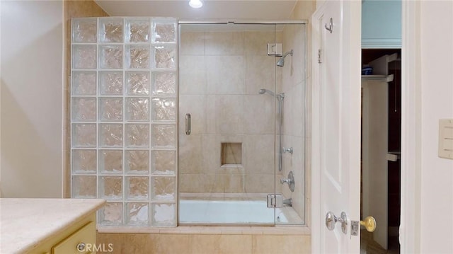 bathroom featuring vanity and enclosed tub / shower combo