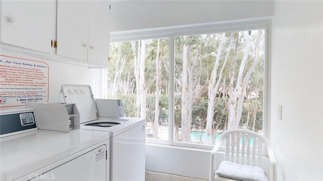 washroom with cabinets and separate washer and dryer