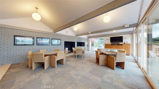 dining area with brick wall, vaulted ceiling with beams, and light carpet