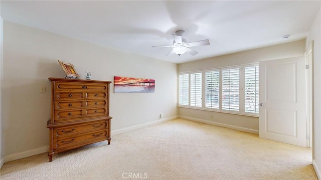 bedroom featuring ceiling fan and light carpet